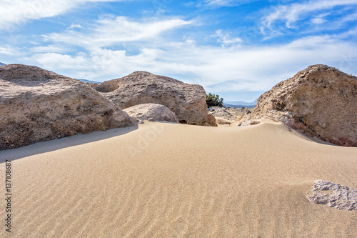 Sand dunes, large stones and blue sky