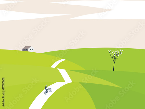 Cyclist riding bicycle on small hills in spring.