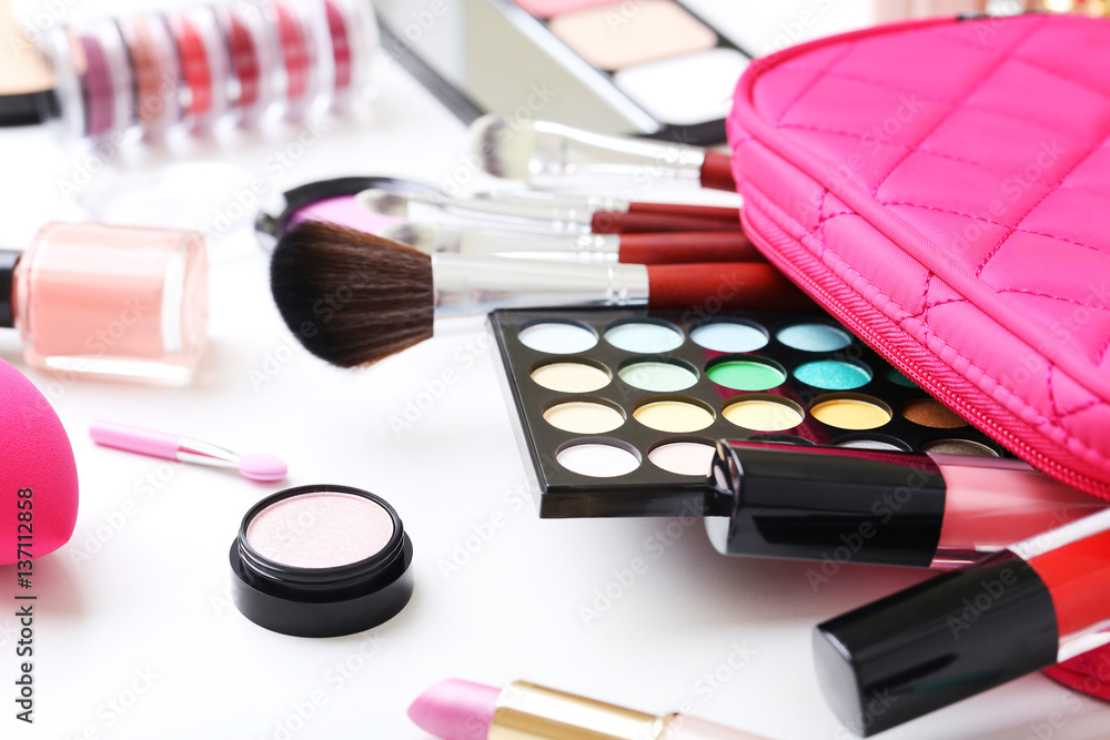 Different makeup cosmetics on white table Different makeup cosmetics on white table