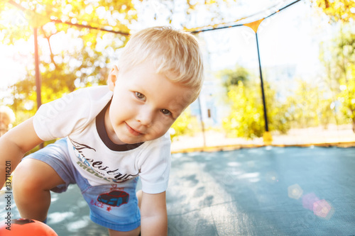 Wallpaper Mural Boy playing, jumping on a trampoline, looking at camera smiling Torontodigital.ca