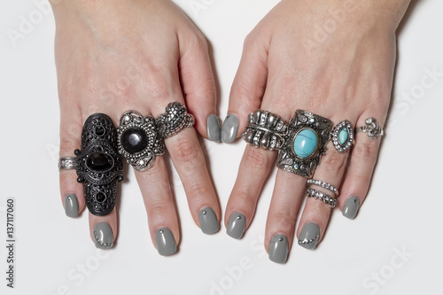 Various silver rock rings with nice manicured fingernails.