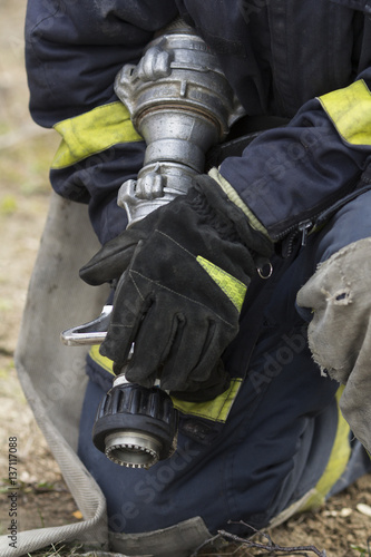 Firefighter holding fire hose