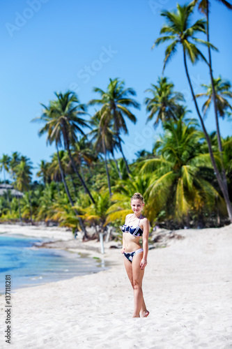 young pretty sexy girl in bikini posing on a tropical beach