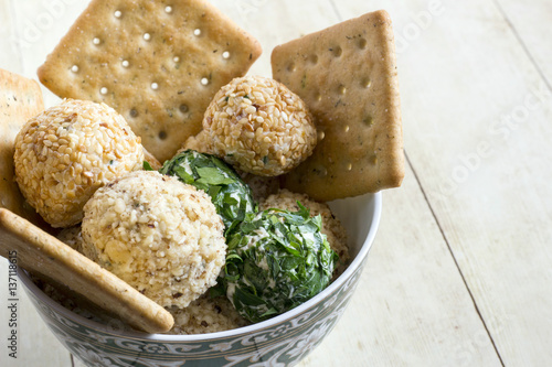 Cheeseballs with crackers on light wood background photo