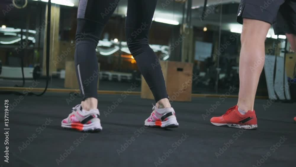 Muscular fit couple doing sport exercises in gym, slow motion Muscular fit couple doing sport exercises in gym, slow motion