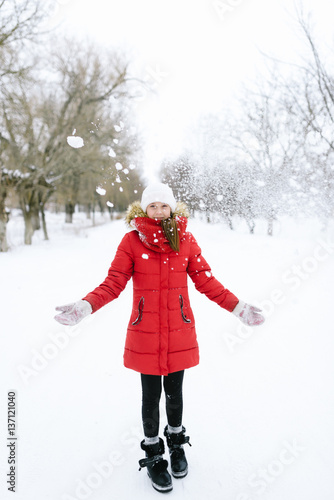 girl in a red jacket in winter photo