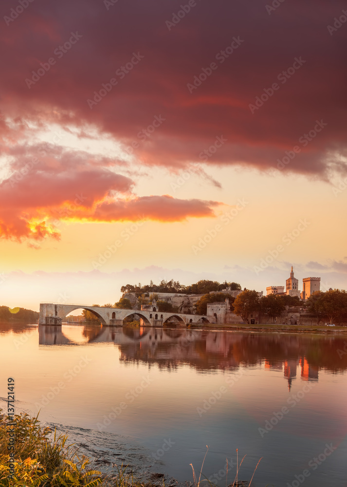 Avignon old bridge against colorful sunset in Provence, France