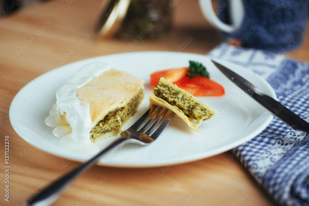 pie with spinach and tomato slice on wooden table. pie with spinach and tomato slice on wooden table.