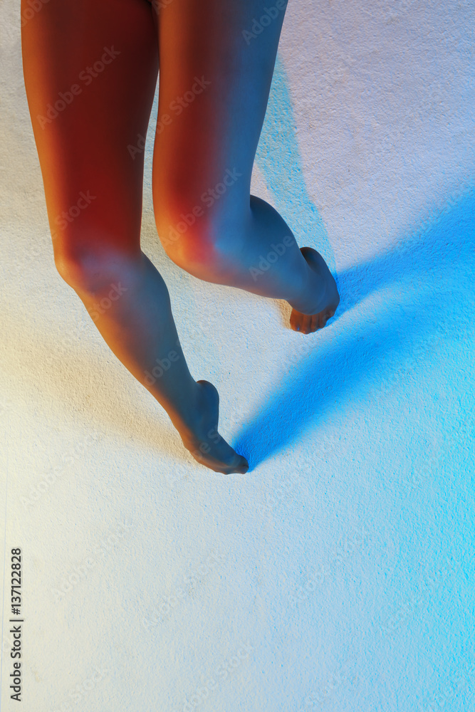 Foto Stock Sexy female legs barefoot in nylon tights against multicolor  texturized background | Adobe Stock