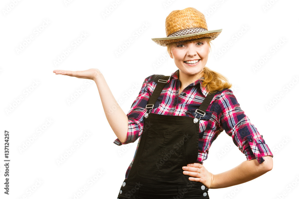 Woman wearing sun hat, showing copyspace on hand Woman wearing sun hat, showing copyspace on hand