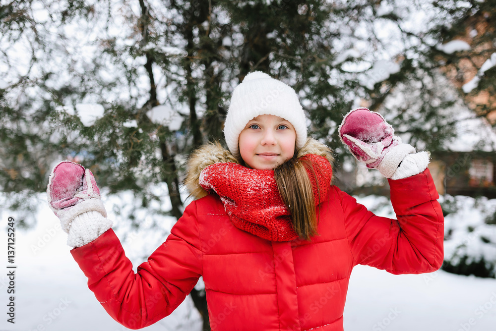 Fototapeta premium girl in a red jacket in winter