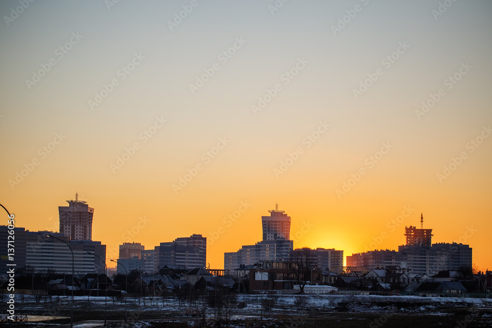 Multi-storey houses of the big city at sunset