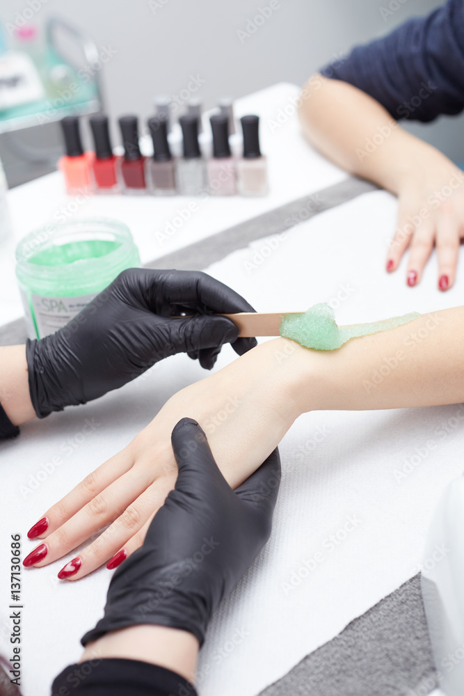 beautician doing Hand massage in beauty salon