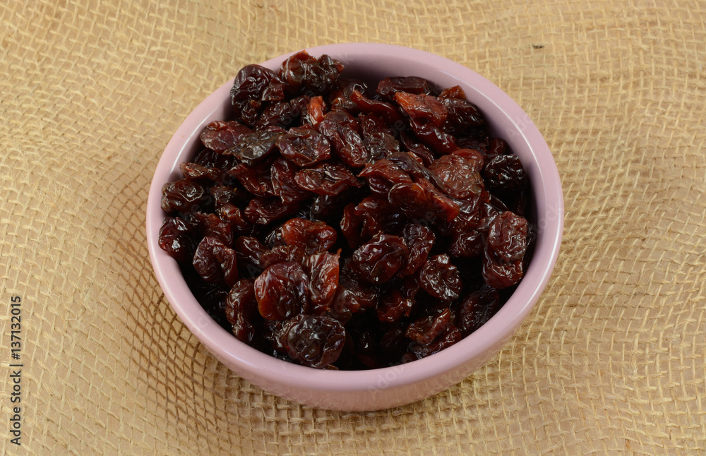 Condiment dish of dried cherries lightly covered in sunflower oil to preserve softness Condiment dish of dried cherries lightly covered in sunflower oil to preserve softness