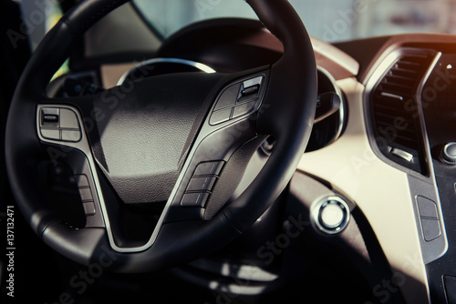 Modern car interior dashboard and steering wheel. © standret