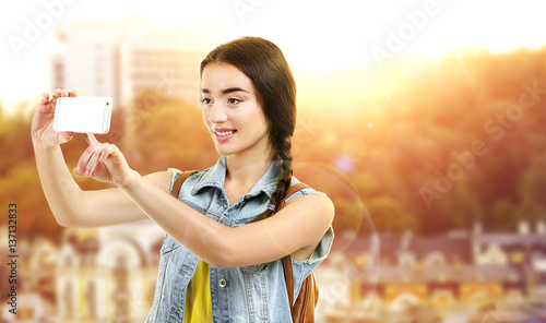 Young woman taking selfie o...