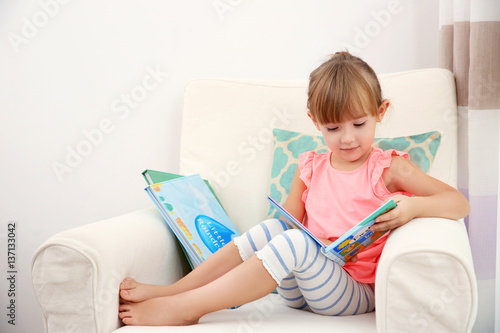 Little cute girl reading book