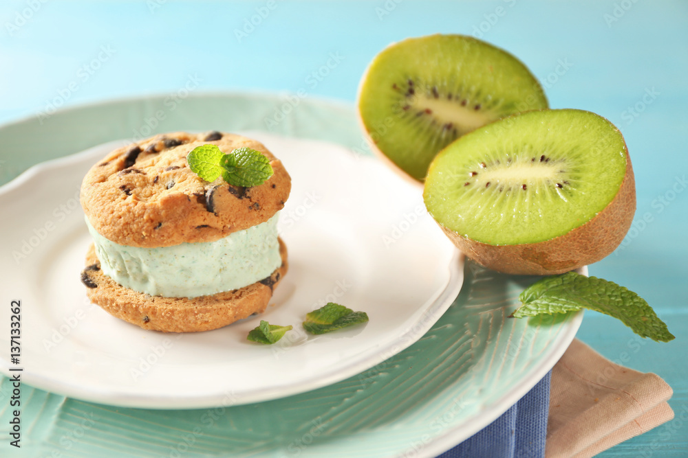 Plate with delicious ice cream cookie sandwich and kiwi, closeup Plate with delicious ice cream cookie sandwich and kiwi, closeup