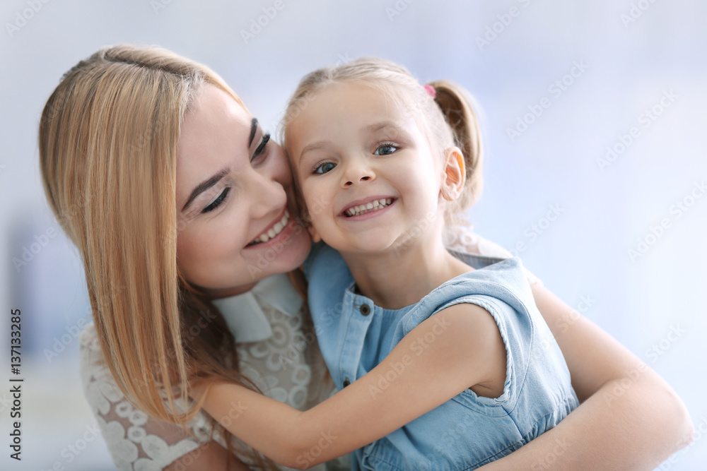 Beautiful young woman and her daughter at home. Mother's day concept Beautiful young woman and her daughter at home. Mother's day concept