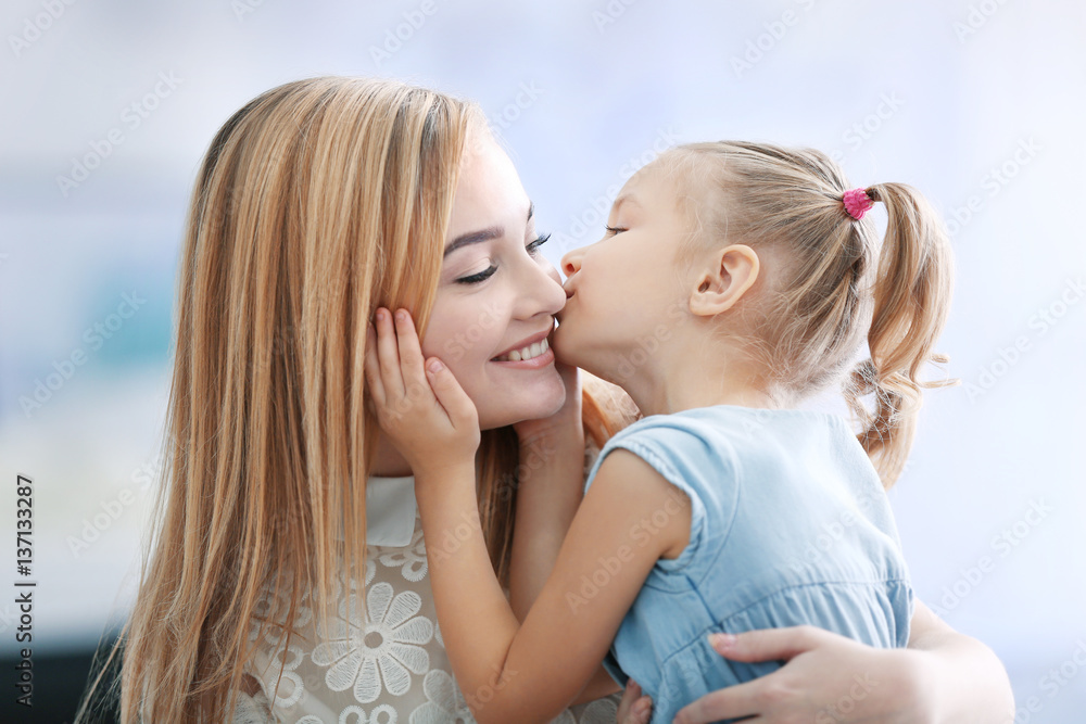 Beautiful young woman and her daughter at home. Mother's day concept Beautiful young woman and her daughter at home. Mother's day concept