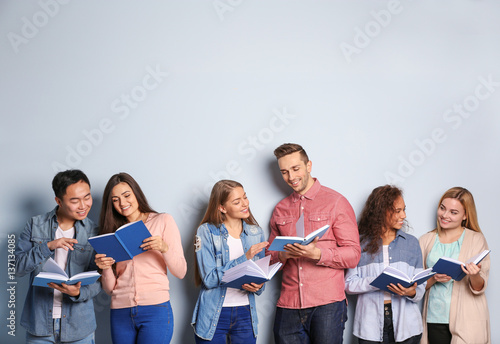 People with books standing ...