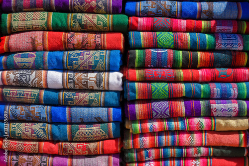 A pile of colorful rugged Peruvian textile and fabrics.