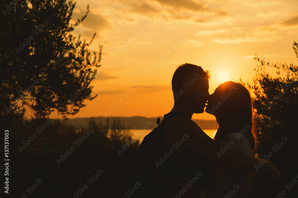 Сouple kissing on the sunset at the Garda Lake, Italy.