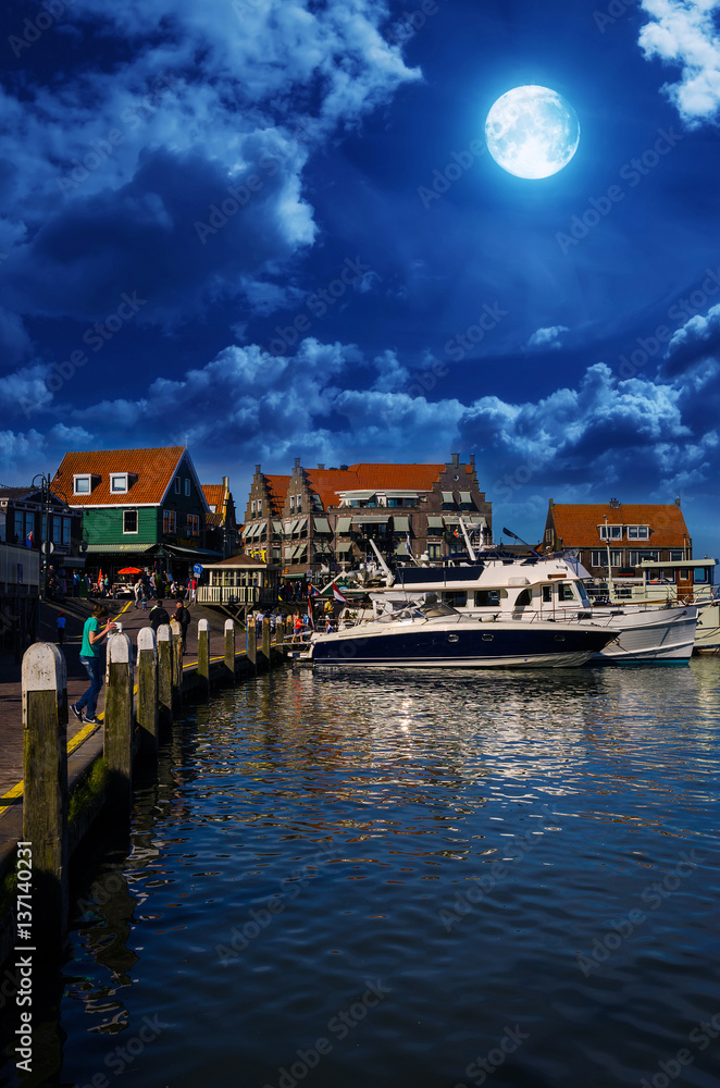 Traditional houses and small vessels in Holland town Volendam, Netherlands.