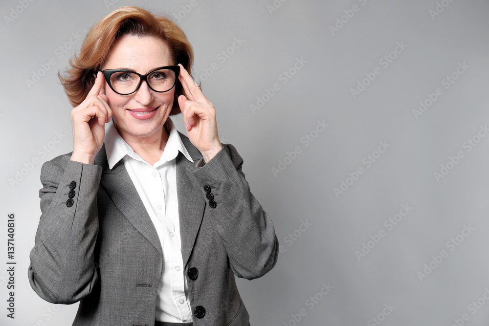 Portrait of gorgeous senior woman with eyeglasses on colour background Portrait of gorgeous senior woman with eyeglasses on colour background