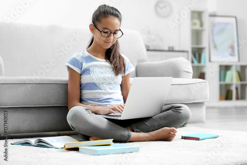 Cute girl with laptop at home
