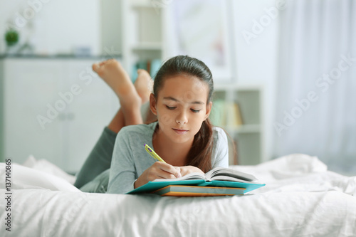 Cute girl doing lessons at ...