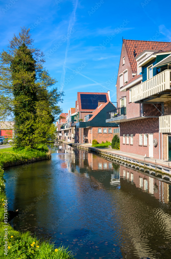 Traditional houses and small vessels in Holland town Volendam, Netherlands