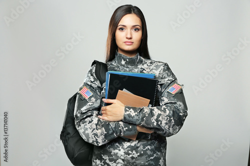 Foto Pretty female cadet of military school on grey background