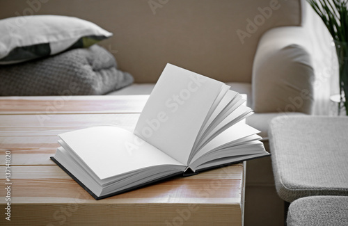 Opened book on wooden table