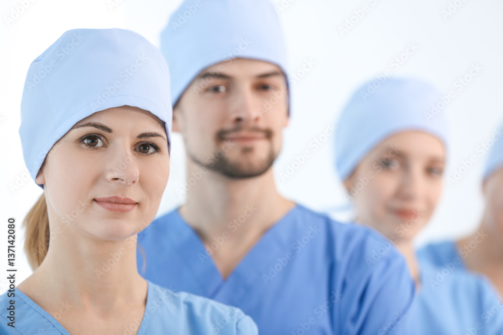 Beautiful young doctor with colleagues in clinic Beautiful young doctor with colleagues in clinic