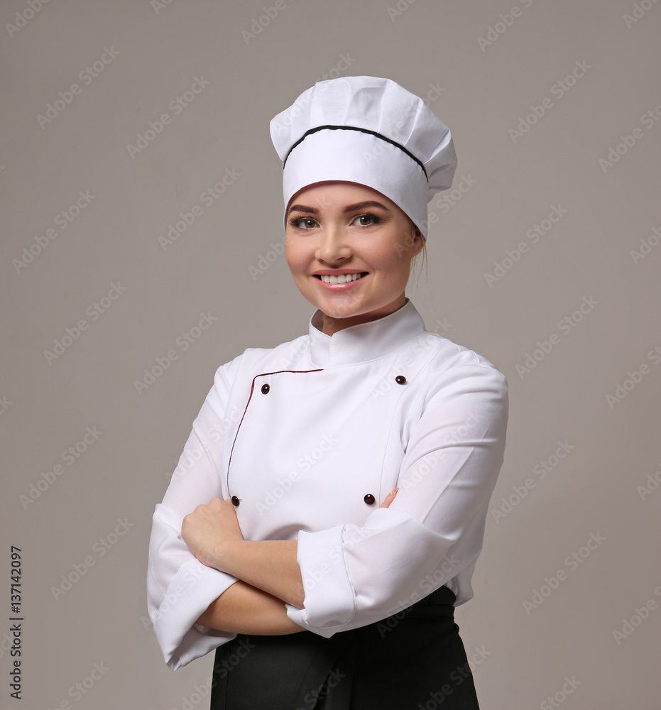 Portrait of young woman chef on light background Portrait of young woman chef on light background