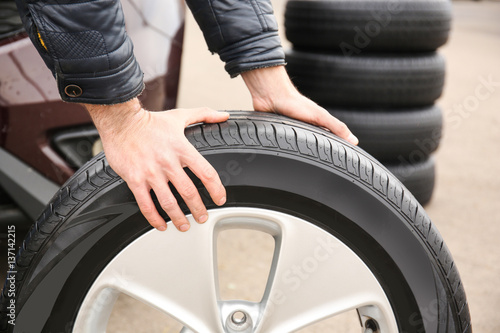 Closeup view of man rolling wheel outdoors © Africa Studio