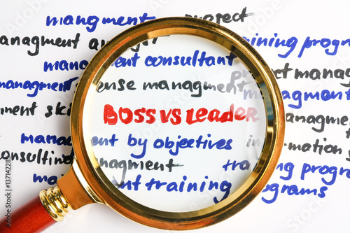 Magnifier increasing text BOSS VS LEADER, closeup