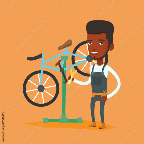 African bicycle mechanic working in repair shop.