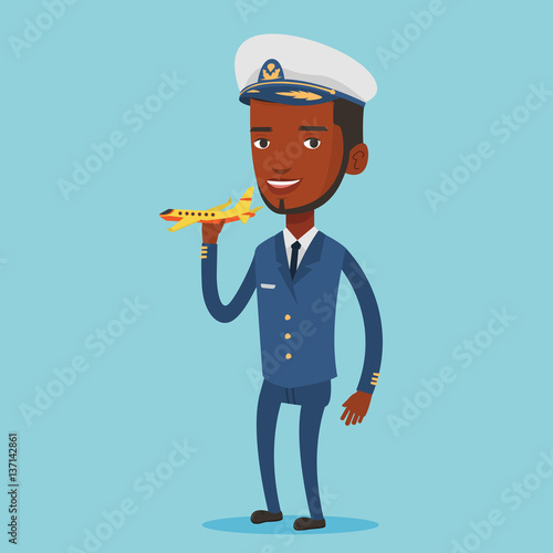 Cheerful airline pilot with model of airplane.