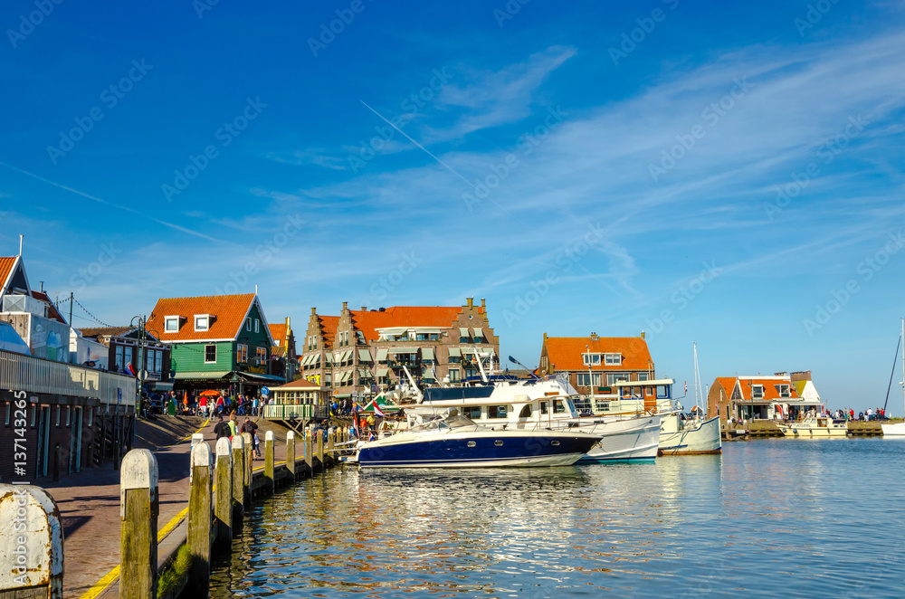 Traditional houses and small vessels in Holland town Volendam, Netherlands