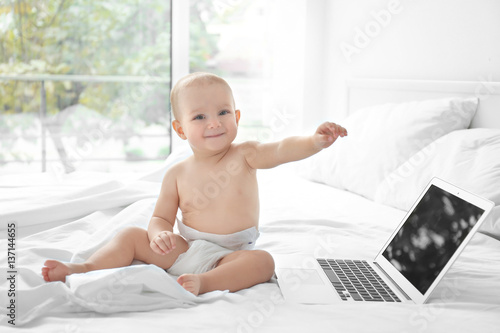 Cute baby boy with laptop o...