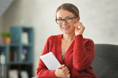 Young woman with tablet sit...