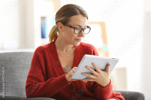 Young woman with tablet sit...