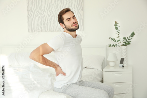 Handsome man feeling back p...