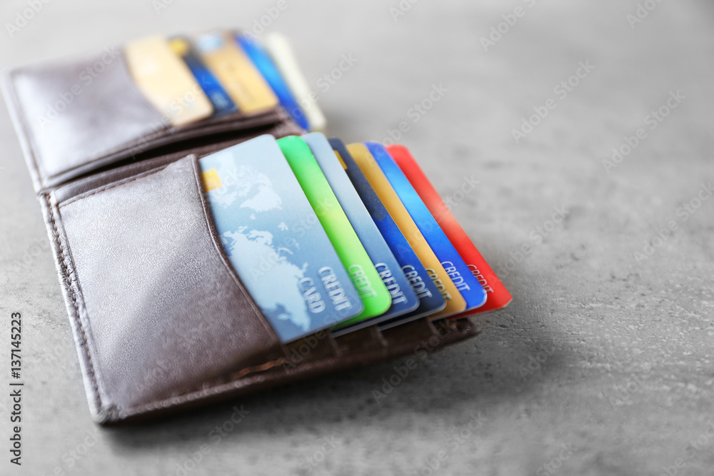 Opened brown leather wallet with credit cards, closeup Opened brown leather wallet with credit cards, closeup