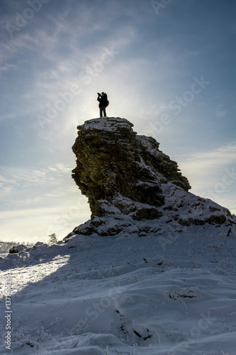 Traveler standing at the top of hill and looking at the amazing landscape.