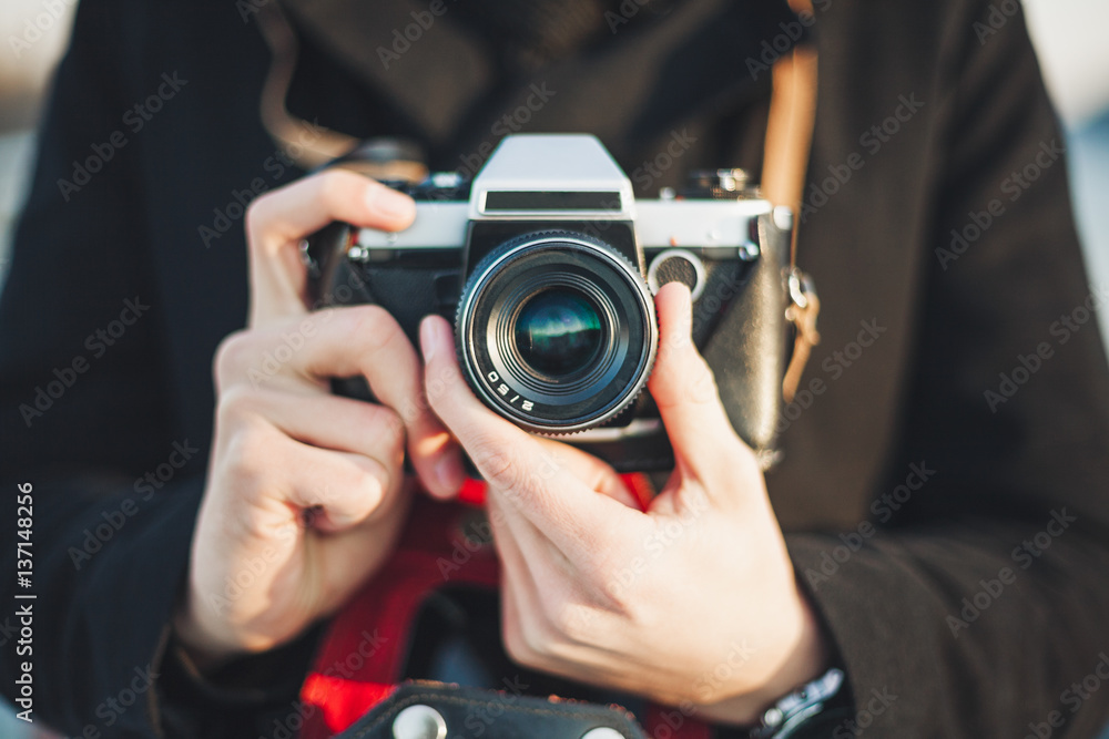 Hipster photographer taking photo with retro camera Hipster photographer taking photo with retro camera