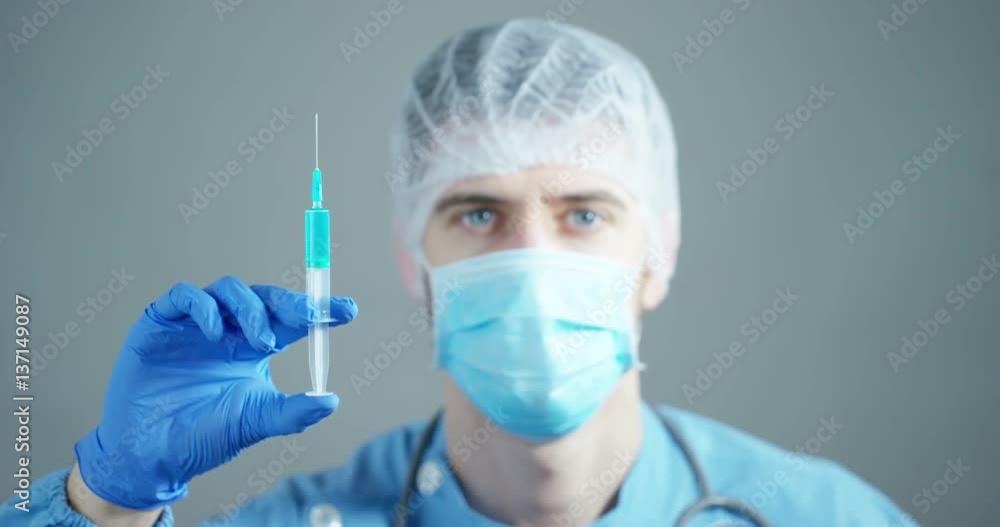 A doctor or scientist in laboratory holding a syringe with liquid vaccines for children or older adults, or cure animal diseases. Concept:diseases,medical care,science, anesthesia,euthanasia,diabetes. A doctor or scientist in laboratory holding a syringe with liquid vaccines for children or older adults, or cure animal diseases. Concept:diseases,medical care,science, anesthesia,euthanasia,diabetes.