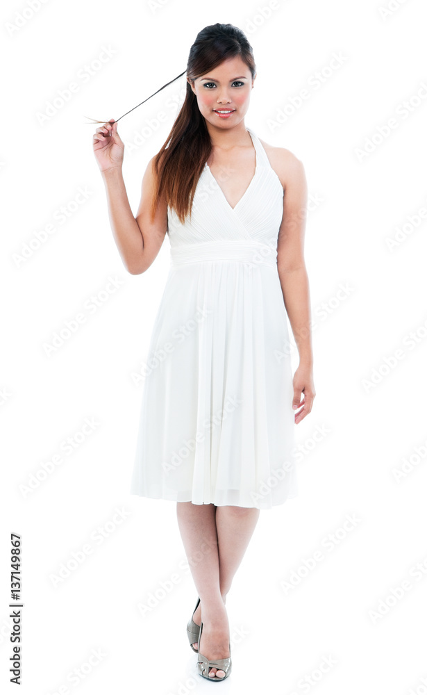 Elegant young woman in white dress holding her tail hair on white background Elegant young woman in white dress holding her tail hair on white background